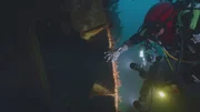 A diver inspects the wreck of the Amoco Cadiz. (National Geographic)