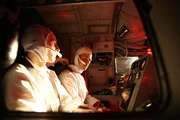 Astronauts at control panel. Astronauts at control panel.