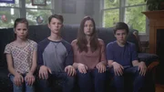 The Fuss children sitting on the couch.