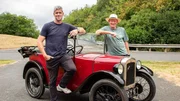 Ant Anstead, wearing blue tshirt and jeans, Nigel Anstead, standing either side of the Austin 7, both leaning on windscreen, shot taken at millbrook proving ground. trees and road in background, full car in shot Ant Anstead, wearing blue tshirt and jeans, Nigel Anstead, standing either side of the Austin 7, both leaning on windscreen, shot taken at millbrook proving ground. trees and road in background, full car in shot