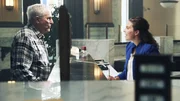 Ed speaks with bank teller. Ed speaks with bank teller.