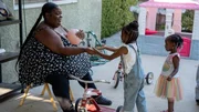 Nesha Harris playing with two children at daycare.