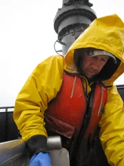 Closeup of Derek Haist measuring crab on the Seabrooke.