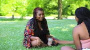 Ashley laughs with her sister Sienna while sitting in the park while drinking a coffee. Ashley laughs with her sister Sienna while sitting in the park while drinking a coffee.
