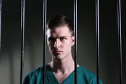 Recre- Larry Ranes looking through jail cell bars. Recre- Larry Ranes looking through jail cell bars.