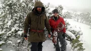 Grady Powell and Josh James geared up in the snow with the bag of resources in Bulgaria.