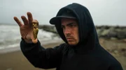 Chris McCully holding gold nugget soft focus Chris McCully holding gold nugget soft focus