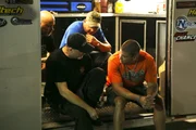 Doc huddles with the Alvarez brothers before his race against Murder Nova