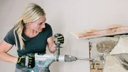Jasmine Roth removes the old stones from the fireplace. Jasmine Roth removes the old stones from the fireplace.