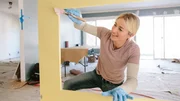 Jasmine Roth paints the nook underneath the stairs. Jasmine Roth paints the nook underneath the stairs.