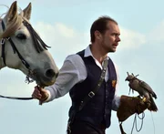 Jonathan Marshall leads his horse, a Lusitano Gelding called Tulio, while the Peregrine Tiercel falcon, Morgan, perches on his hand. Jonathan Marshall leads his horse, a Lusitano Gelding called Tulio, while the Peregrine Tiercel falcon, Morgan, perches on his hand.