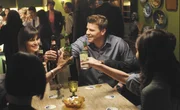 Brennan (Emily Deschanel, L) and Booth (David Boreanaz, R) enjoy and evening with the Jeffersonian Team. Brennan (Emily Deschanel, L) and Booth (David Boreanaz, R) enjoy and evening with the Jeffersonian Team.