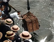 Harry Houdini At Work A man lowers a wooden box which contains Hungarian-born American magician, escape artist, and psychic debunker Harry Houdini into the East River as part of one of the beloved entertainers amazing feats of escapology, New York, July 7, 1912. Houdini returned to the surface within one minute of the box sinking below the water. (Photo by FPG/Getty Images)