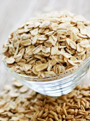 Bowl of uncooked rolled oats Bowl of uncooked rolled oats
