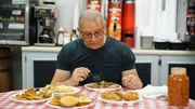 Chef Robert Irvine samples menu items at Walters Gas and Grill, prior to renovations, as seen on Restaurant Impossible, season 20