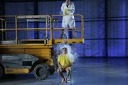 ESSEX, ENGLAND - In the ice bucket challenge Matt Chancellor pours a bucket of ice water from a platform onto Ben Layton's head demonstrating the center of mass. ESSEX, ENGLAND - In the ice bucket challenge Matt Chancellor pours a bucket of ice water from a platform onto Ben Layton's head demonstrating the center of mass.