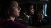 Betty and Barney Hill looking shocked and scared as they approach the UFO that later abducted them