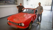 Mike on left side of beaten up red Anadol, arm resting on car, Elvis on right hand of car, arm resting on car Mike on left side of beaten up red Anadol, arm resting on car, Elvis on right hand of car, arm resting on car