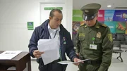 Ein Einwanderungsbeamter zeigt der Polizei Dokumente. Bogota, Kolumbien. Ein Einwanderungsbeamter zeigt der Polizei Dokumente. Bogota, Kolumbien.