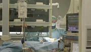 Konzentrierte Arbeit im OP: W&auml;hrend der Monitor stabile Werte anzeigt, operiert das Team unter sterilen Bedingungen.