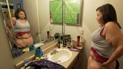 Brittani looks at her excess stomach skin before she has it removed surgically. Brittani looks at her excess stomach skin before she has it removed surgically.