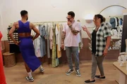 Jamal Menzies dances in a dress while Joshua Weinstein and Kimberly Menzies laugh in a boutique. Jamal Menzies dances in a dress while Joshua Weinstein and Kimberly Menzies laugh in a boutique.