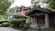 Exterior of A Maze-Ing Arc house, as seen on Ugliest House In America, Season 7.