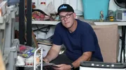 Mike Kelleher posing in client's hoarded storage container