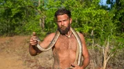 Steven holding a snake around his shoulders.