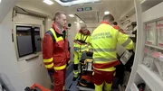 Doc Caro mit der Patientin Marya und Rettungssanit&auml;tern im Rettungswagen.