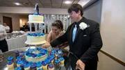 Joe and Sarah cut their wedding cake.