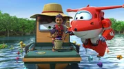Jett will Nita aus Kambodscha helfen, Unmengen Badespielzeug aus einem Fluss zu fischen.