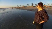 Melissa takes in the views at a beach. Melissa takes in the views at a beach.