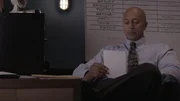 Demery looks at a page at his desk.