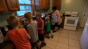 Bettie Jo making dinner with relatives of Josh helping her in the kitchen.