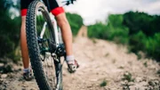 Spain, Tarragona, Mountain biker in extreme terrain, low section, rear view Spain, Tarragona, Mountain biker in extreme terrain, low section, rear view