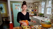 Candid shot of Molly Yeh making her Cheeseburger Potato Soup, as seen on Girl Meets Farm, Season 8.