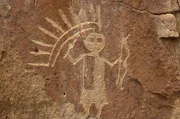 D2ADT0 New Mexico. Largo Canyon. Petroglyphs. Man Wearing Headdress Holding Bow And Arrow.