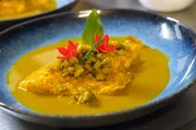 Das Gericht vereint frischen Fisch mit der aromatischen Colombo-Gew&uuml;rzmischung und kreolischen Zutaten und symbolisiert die kulturelle Vielfalt der Insel.