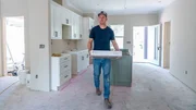 Brian and Mika Kleinschmidt work on installing a cabinet, as seen on 100 Day Dream Home, Season 6.
