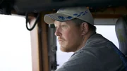 Co-Captain of the Cornelia Marie, Casey McManus, at the helm.