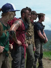 Wide hero shot of (L-R) Sam, Parker, Fred, Karla overlooking the landscape of PNG side facing Wide hero shot of (L-R) Sam, Parker, Fred, Karla overlooking the landscape of PNG side facing