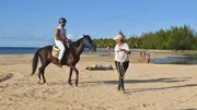 Pedro Jimeno Morel rides a horse on a beach led by Nicole. Pedro Jimeno Morel rides a horse on a beach led by Nicole.