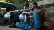 Recreation of two men that were a part of Travis Walton's logging crew on the way to work on the back of a truck