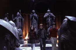 Hermione (Emma Watson), Ron (Rupert Grint, M.) und Harry (Daniel Radcliffe) gelangen in einen Zauberraum, der aussieht wie ein Schachbrett.