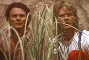 Der Profikiller Murdoc (Michael des Barres, l.) und MacGyver (Richard Dean Anderson, r.) beobachten das Clubhaus von Nicholas Melman. Der Profikiller Murdoc (Michael des Barres, l.) und MacGyver (Richard Dean Anderson, r.) beobachten das Clubhaus von Nicholas Melman.