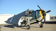 Wide, full length of Parking standing on the wing of the Avenger, posing &ndash; outside.