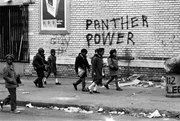 Children walk by Panther Power graffiti. Children walk by Panther Power graffiti.
