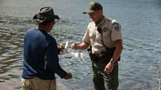 Officer Jon ensuring a fisherman is logging his catch.