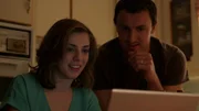 Vanessa and Ken sitting at a computer in the kitchen.